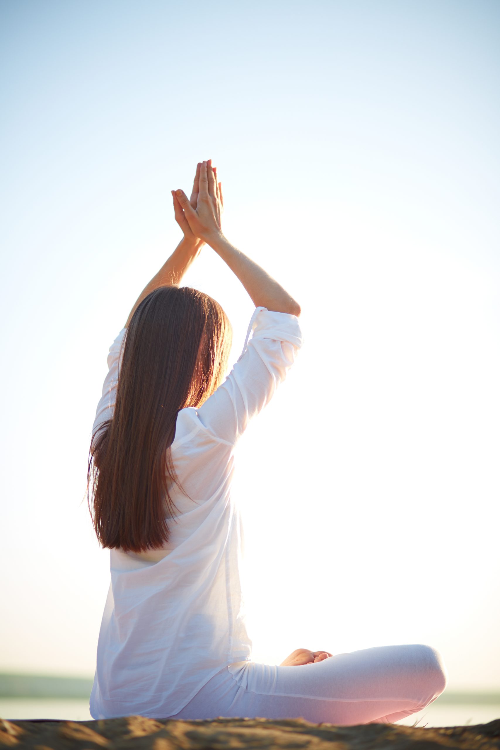 Unity of body and mind Side view of young woman doing yoga against clear sky outdoors